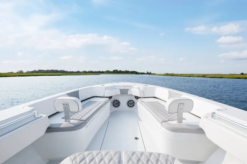 Slide: The Image of 2025 Contender 32 ST boat interior on calm water under blue sky. - 14