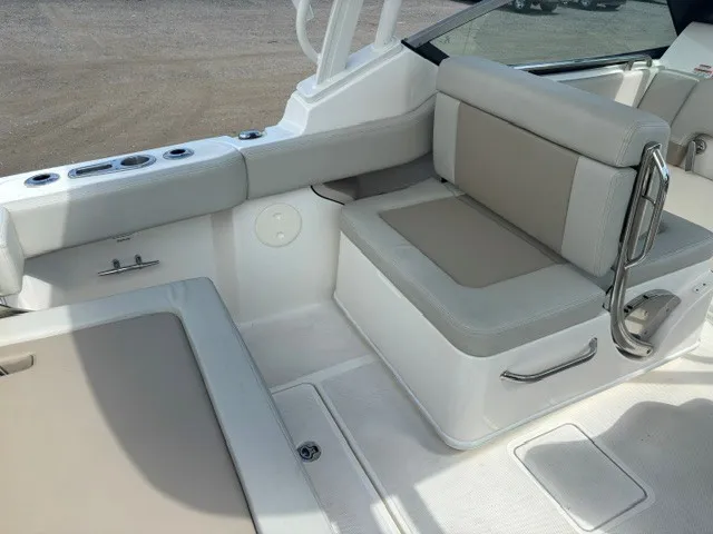 Slide: The Image of The image shows the seating area of a 2025 Boston Whaler 240 Vantage boat with beige upholstery. - 13
