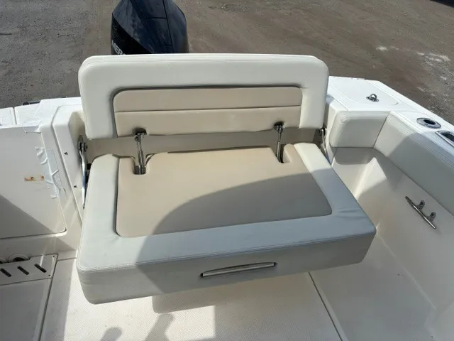 Slide: The Image of The 2025 Boston Whaler 240 Vantage features a comfortable, cushioned bench seat in the rear area. - 12