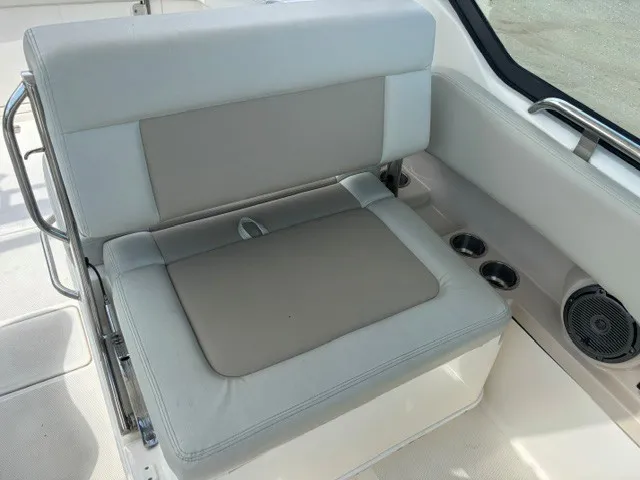 Slide: The Image of The 2025 Boston Whaler 240 Vantage features a comfortable bench seat with cup holders and a speaker. - 9