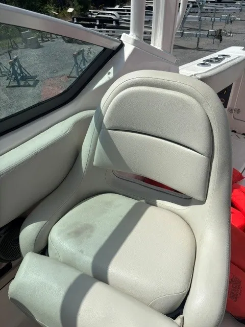 Slide: The Image of A beige leather seat on a boat, surrounded by a white railing and a window. - 7