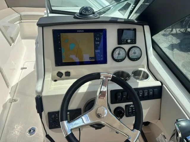 Slide: The Image of The image shows the helm of a Boston Whaler 240 Vantage boat with modern instruments. - 8