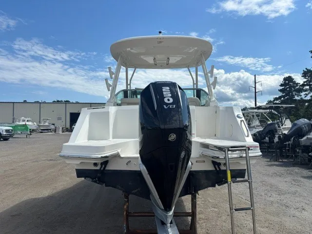 Slide: The Image of A 2025 Boston Whaler 240 Vantage with a large outboard motor, on a dry dock. - 1