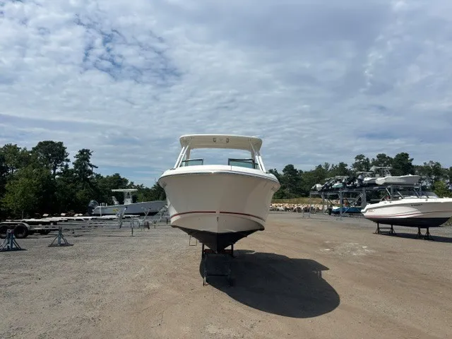 Slide: The Image of A Boston Whaler 240 Vantage boat is on a dry dock under a cloudy sky. - 3