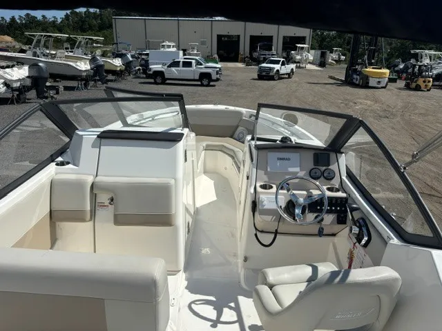 Slide: The Image of The image shows the cockpit of a 2025 Boston Whaler 210 Vantage with modern instruments. - 16