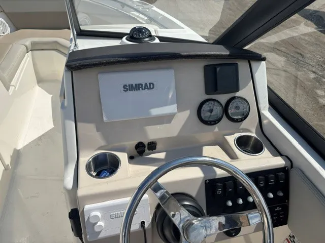 Slide: The Image of The 2025 Boston Whaler 210 Vantage cockpit features a modern helm with Simrad electronics. - 14