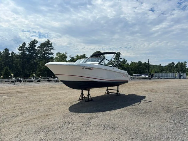 Slide: The Image of A 2025 Boston Whaler 210 Vantage is on a dry dock under a cloudy sky. - 3