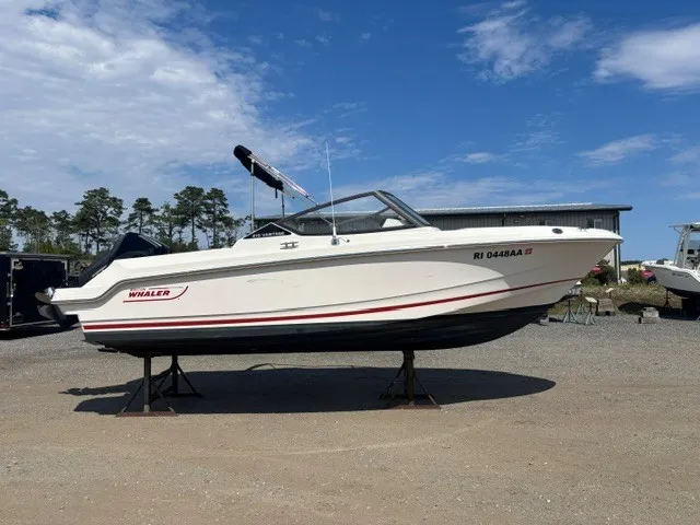 The Image of A 2025 Boston Whaler 210 Vantage is on a dry dock. The sky is partly cloudy. - 0