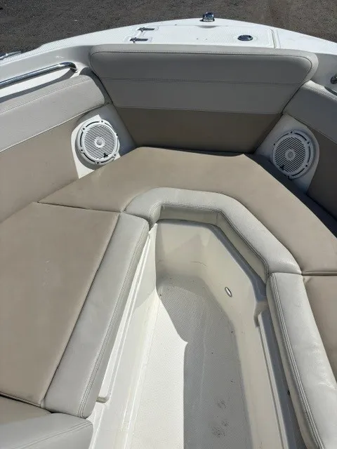Slide: The Image of The image shows the bow area of a 2025 Boston Whaler 210 Vantage with cushioned seating and speakers. - 8