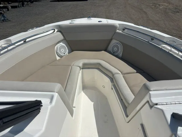 Slide: The Image of The 2025 Boston Whaler 210 Vantage features a spacious bow area with cushioned seating and speakers. - 12