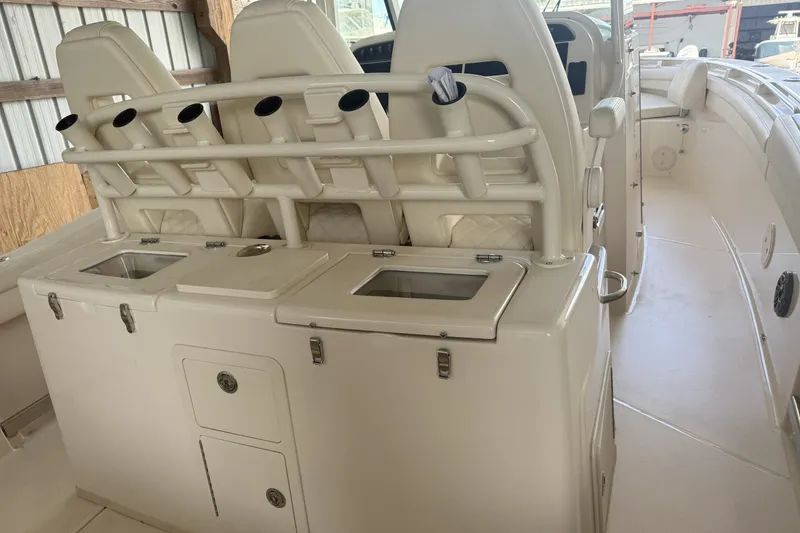 Slide: The Image of 2026 Grady-White Canyon 336 boat interior with rod holders and storage compartments. - 31