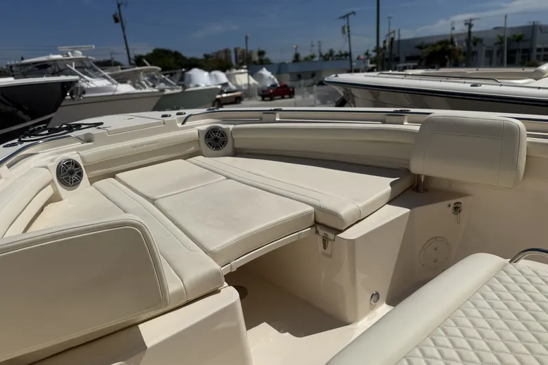 Slide: The Image of 2026 Grady-White Canyon 336 boat interior with cushioned seating and speakers. - 21