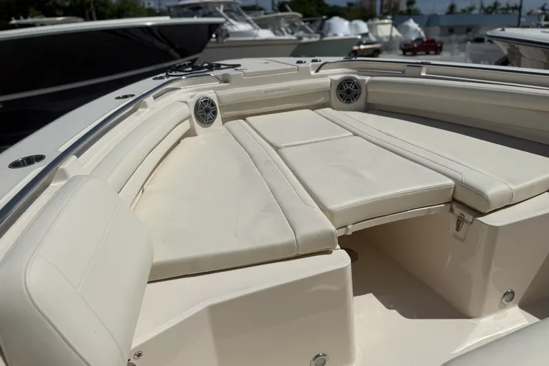Slide: The Image of 2026 Grady-White Canyon 336 boat interior with cushioned seating and speakers. - 20