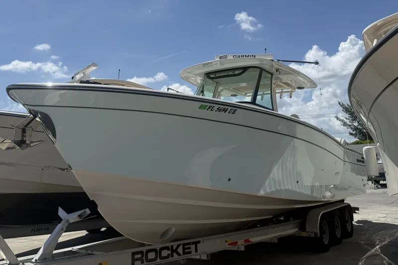 The Image of 2026 Grady-White Canyon 336 boat on trailer under clear blue sky. - 0