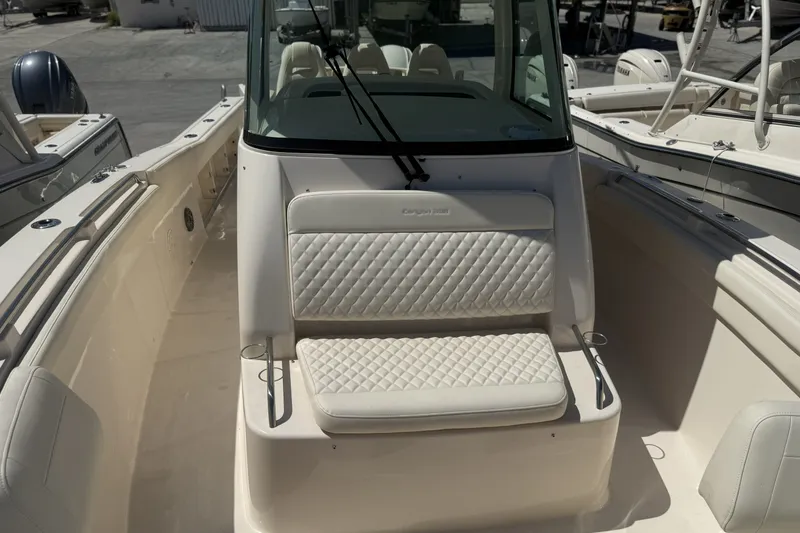 Slide: The Image of 2026 Grady-White Canyon 336 boat interior with cushioned seating and sleek design. - 22