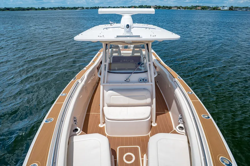 Slide: The Image of 2015 Grady-White Canyon 306 boat on water, featuring spacious deck and seating. - 44