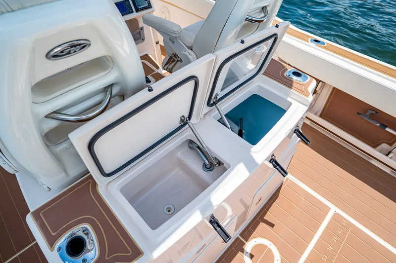 Slide: The Image of 2015 Grady-White Canyon 306 boat interior with open storage compartments. - 27