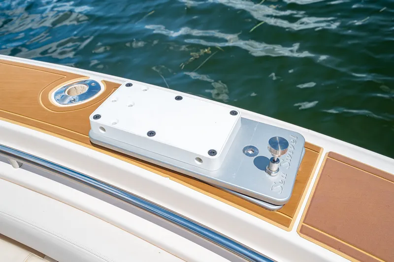 Slide: The Image of 2015 Grady-White Canyon 306 boat detail with teak accents and metal fittings on water. - 46