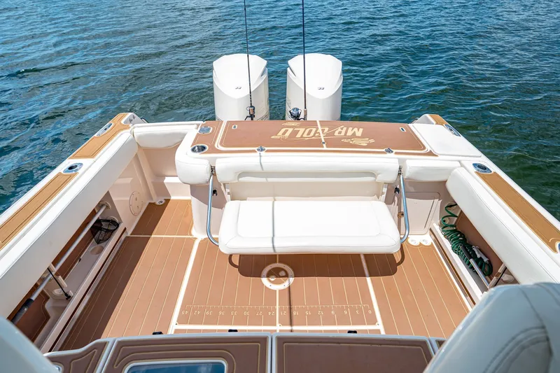 Slide: The Image of 2015 Grady-White Canyon 306 boat deck with seating and twin engines on water. - 21