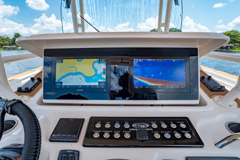 Slide: The Image of Dashboard of 2015 Grady-White Canyon 306 boat with Garmin navigation displays. - 38