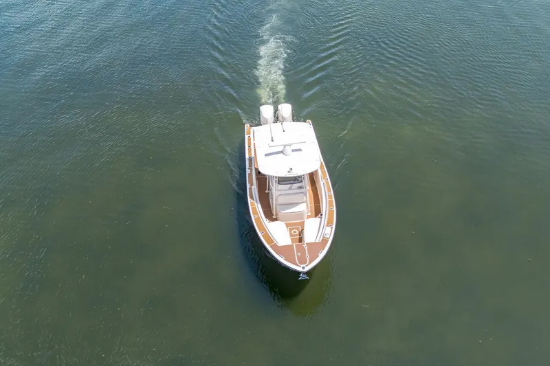 Slide: The Image of Aerial view of 2015 Grady-White Canyon 306 boat cruising on calm water. - 19
