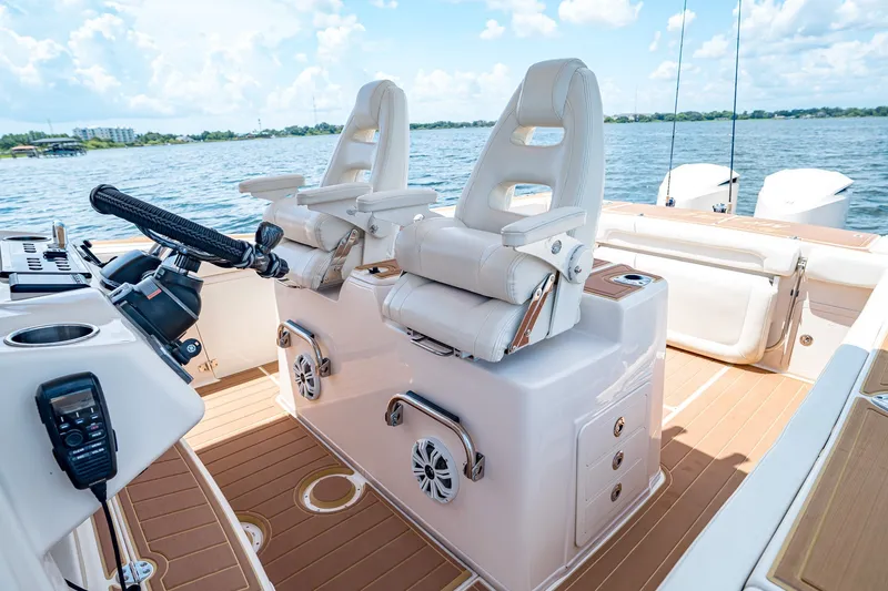 Slide: The Image of 2015 Grady-White Canyon 306 boat interior with helm seats and steering wheel. - 34