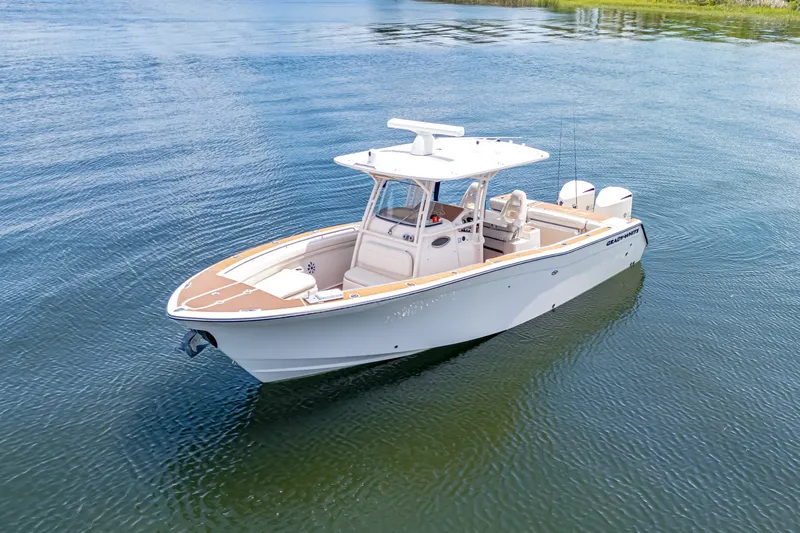The Image of 2015 Grady-White Canyon 306 boat on calm water, showcasing sleek design and spacious deck. - 1