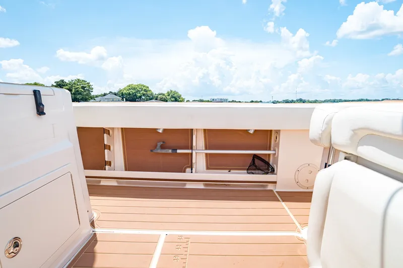 Slide: The Image of 2015 Grady-White Canyon 306 boat interior with teak flooring and storage compartments. - 23