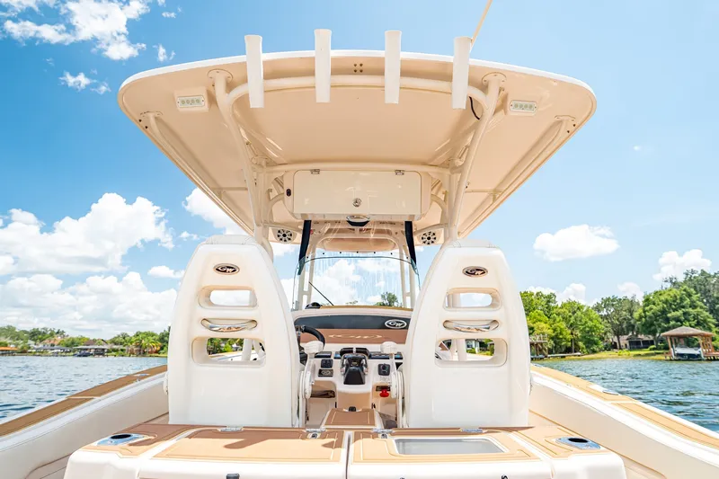 Slide: The Image of 2015 Grady-White Canyon 306 boat interior with helm, under clear blue sky. - 41