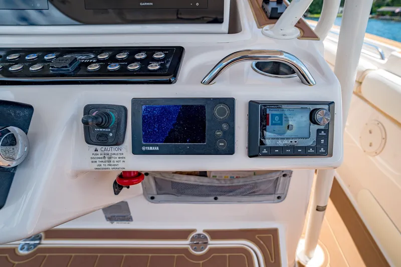 Slide: The Image of Control panel of 2015 Grady-White Canyon 306 boat with Yamaha and JL Audio systems. - 37