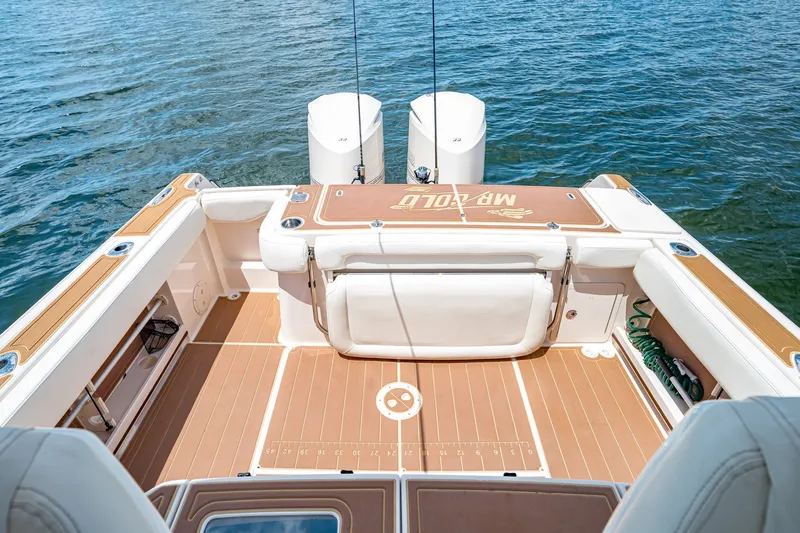 Slide: The Image of 2015 Grady-White Canyon 306 boat deck with twin engines on water. - 22