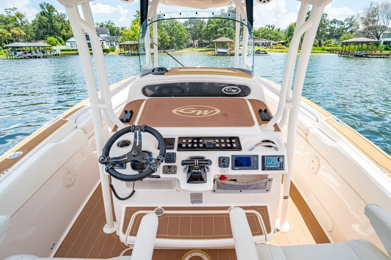 Slide: The Image of 2015 Grady-White Canyon 306 boat cockpit with steering wheel and control panel on water. - 40