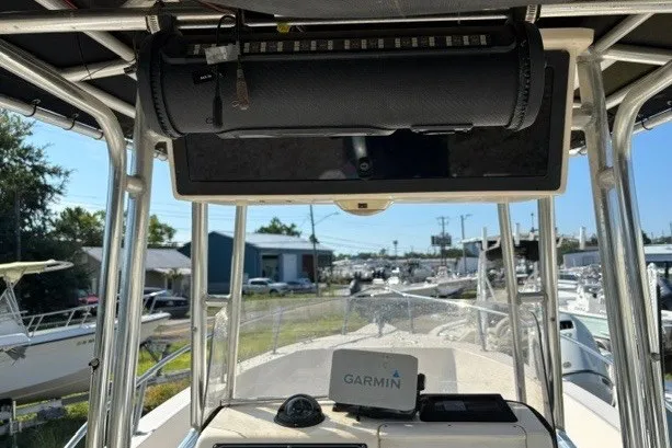 Slide: The Image of 2005 Key West 225 Center Console boat with Garmin navigation system, docked at a marina. - 13
