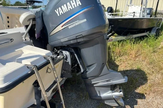 Slide: The Image of 2005 Key West 225 Center Console with Yamaha outboard motor in a grassy area. - 5