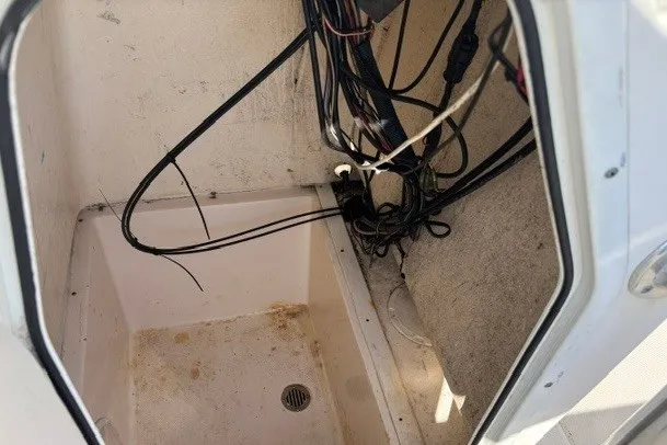 Slide: The Image of 2005 Key West 225 Center Console boat wiring compartment with visible cables. - 7
