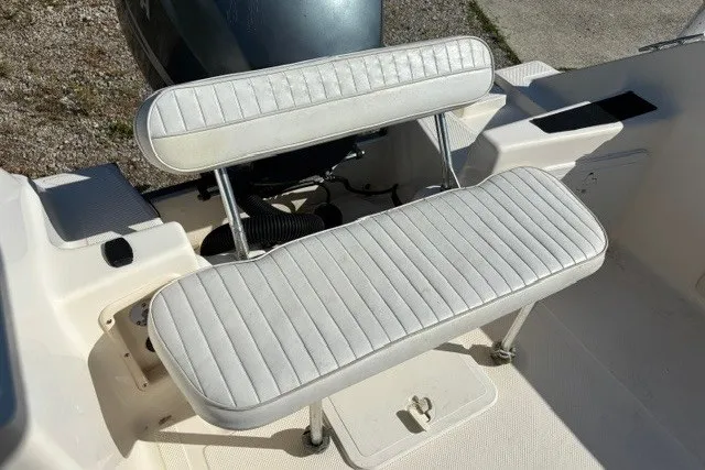 Slide: The Image of 2005 Key West 225 Center Console boat seat with white upholstery. - 11