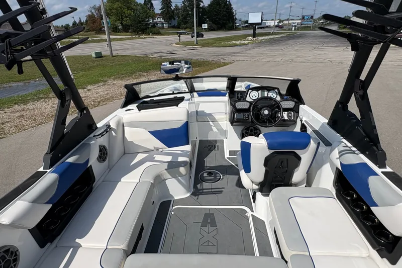 Slide: The Image of 2021 Axis A20 boat interior with blue and white seating, steering wheel, and dashboard. - 10