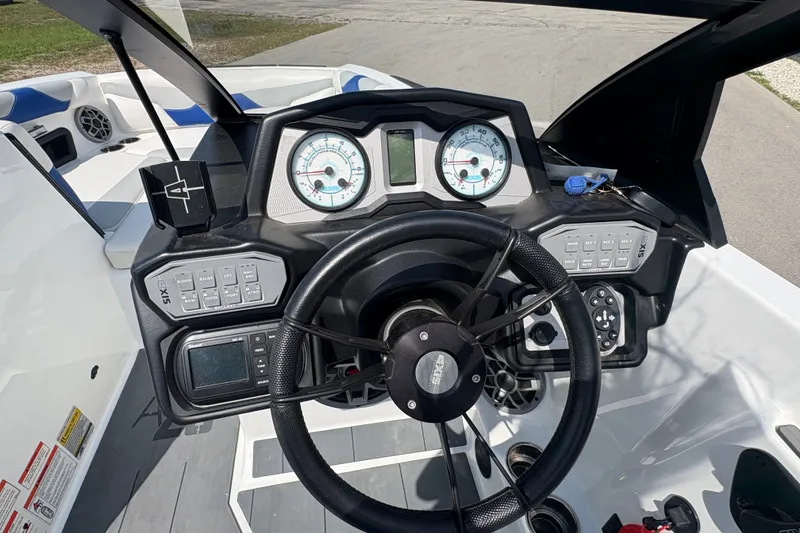 Slide: The Image of Dashboard of a 2021 Axis A20 boat with steering wheel and control panels. - 12