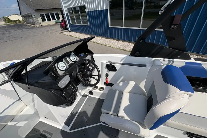 Slide: The Image of 2021 Axis A20 boat interior with steering wheel and dashboard controls. - 11