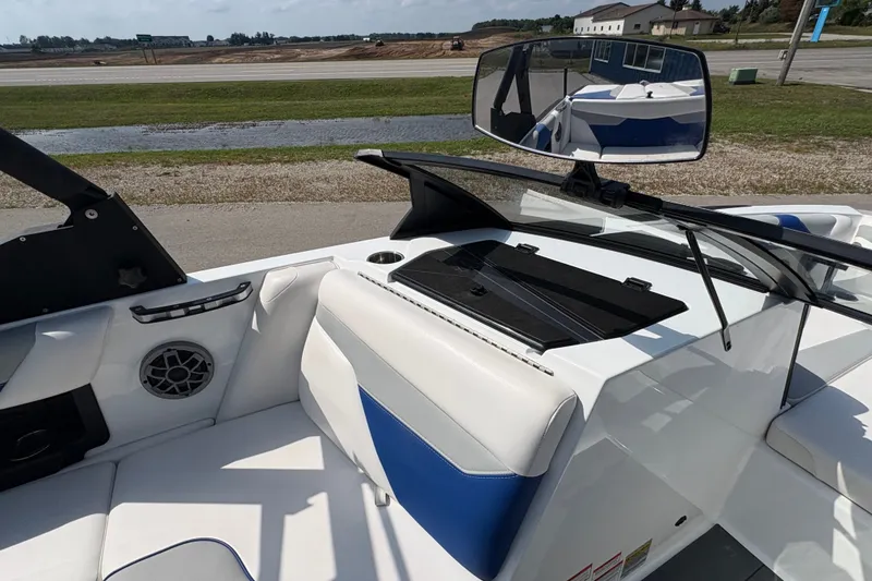 Slide: The Image of 2021 Axis A20 boat interior with white and blue seating, windshield, and rearview mirror. - 15