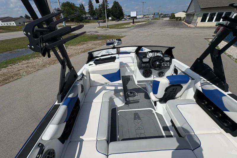 Slide: The Image of 2021 Axis A20 boat interior with blue and white seating, modern dashboard, and spacious layout. - 9