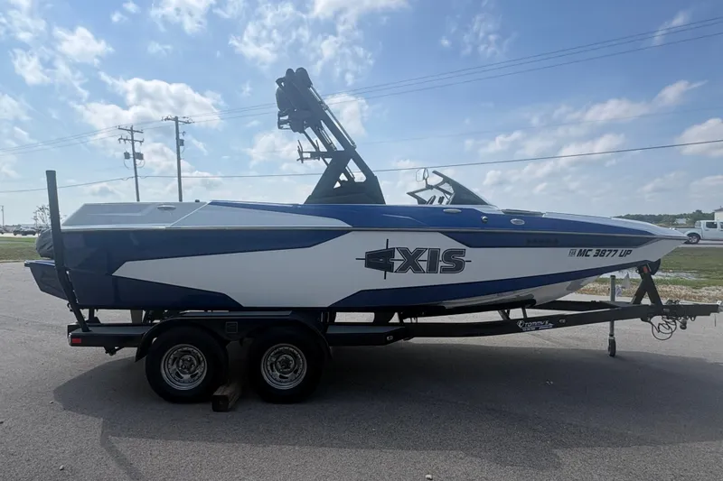 Slide: The Image of 2021 Axis A20 boat on trailer under a clear blue sky. - 3