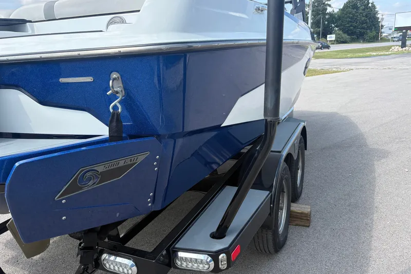 Slide: The Image of 2021 Axis A20 boat on trailer, featuring blue and white exterior design. - 4