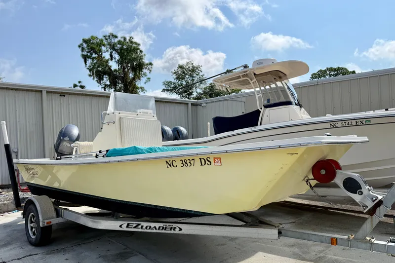 Slide: The Image of 2012 Jones Brothers Bateau 20 boat on trailer, parked outdoors. - 2