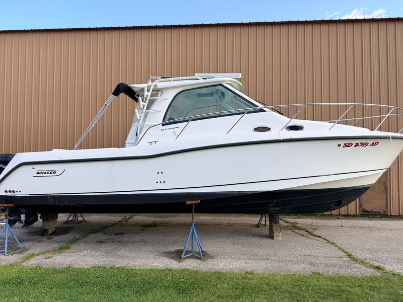 Slide: The Image of A 2013 Boston Whaler 345 Conquest is on stands in front of a large building. - 2