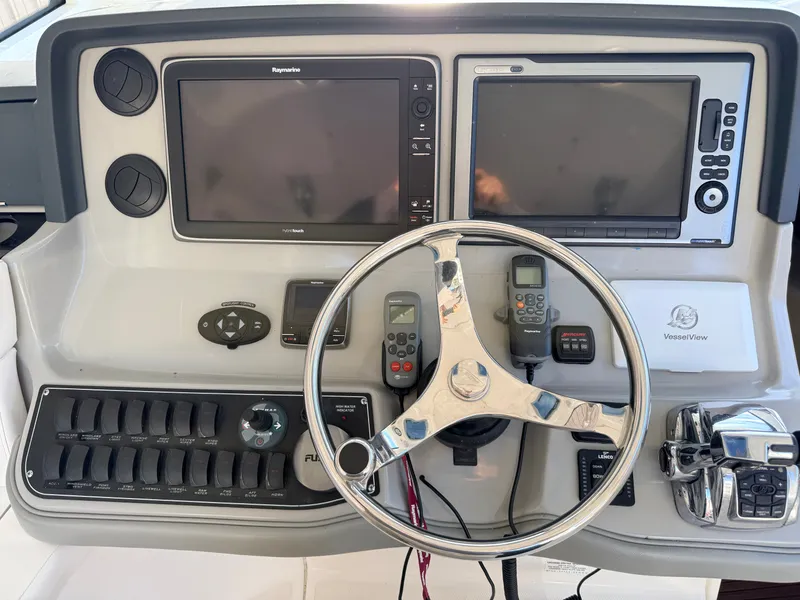 Slide: The Image of The image shows the helm of a 2013 Boston Whaler 345 Conquest with modern navigation systems. - 5
