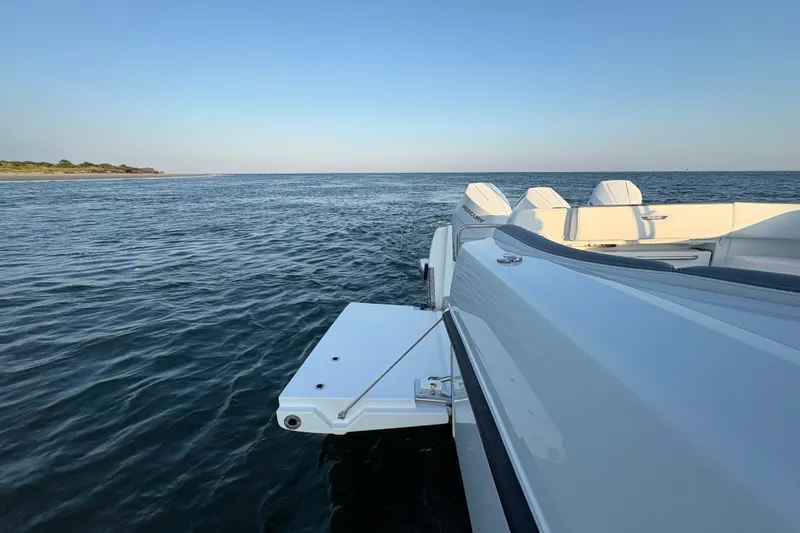 Slide: The Image of 2026 Wellcraft 38 T-Top boat cruising on calm ocean waters. - 13