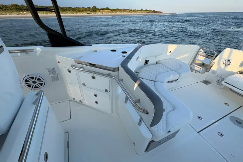 Slide: The Image of 2026 Wellcraft 38 T-Top boat interior with white seating and ocean view. - 18