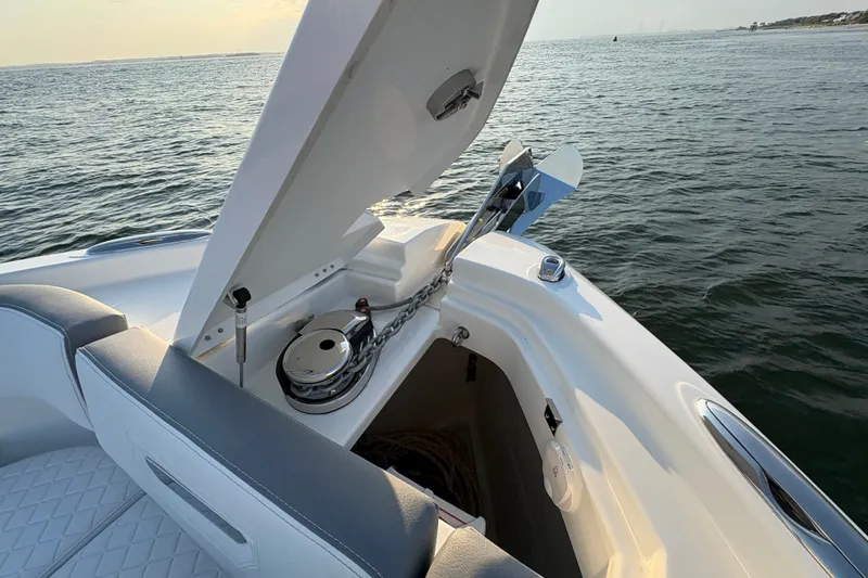 Slide: The Image of 2026 Wellcraft 38 T-Top boat anchor compartment open on calm water. - 21