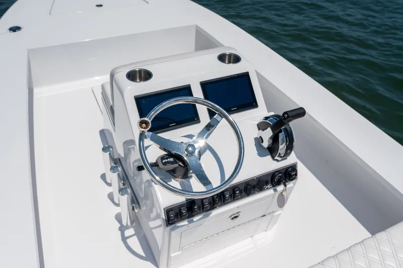 Slide: The Image of Steering console of 2021 Vtech 18 FLATS boat with dual screens and controls. - 15